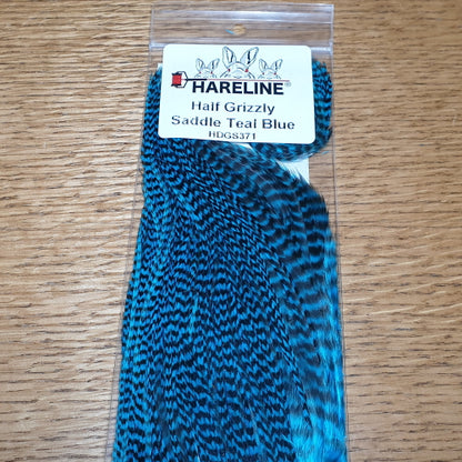 Hareline Grizzly Half Saddle – Teal Blue AVAILABLE AT TROUTLORE FLY TYING STORE AUSTRALIA